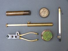 A collection of brass percussion muzzle loading tools and accessories including a bullet moulding .