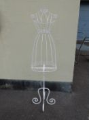 A decorative white clothes stand or mannequin,