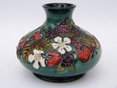 Moorcroft squat vase decorated with berries and flowers no 352 and WM to base (10cm tall)