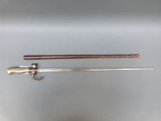 An 1886 French Lebel bayonet with cruciform blade numbered 42011 to quillion,