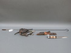 A pair of metal spurs with leather fittings, stag's horn handled hunting knife in leather sheath, .