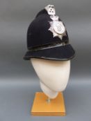 Three vintage police helmets including Thames Valley,