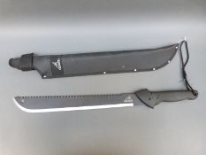 Gerber machete with 47cm saw back blade and textured grip, in protective sheath,