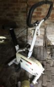 A vintage exercise bike together with a compact rowing machine.