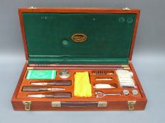 A Parker Hale 12 bore gun cleaning kit including snap caps, oil bottle, cleaning rods etc,