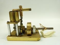 A model marine live steam engine, the single acting cylinder with solid brass flywheel,