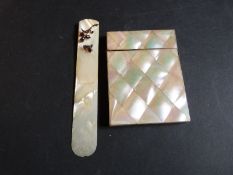 A mother of pearl card case and a mother of pearl page turner with bee and flower to top