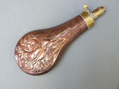 A copper and brass powder flask with embossed decoration of hares and pheasants, 19.5cm long.