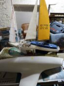 Four various remote control model sailing boats