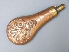 G & J.W Hawksley copper and brass powder flask with embossed scrolling decoration, 20cm long.