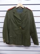 A green Eastern European or Russian ladies police officer's uniform comprising tunic and jacket