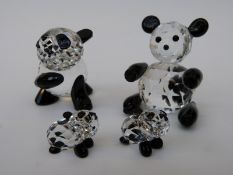 Four Swarovski pandas