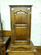 An oak CD cabinet with panelled door and swivel base (H83 x W41 x D41cm)