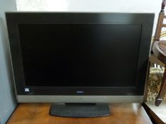 A Hitachi 32 inch flatscreen television and accessories