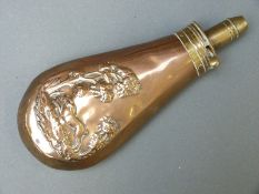 A copper and brass powder flask with embossed decoration of hare in a field,