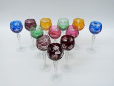 A set of 12 flash overlaid cut glass hock glasses with faceted octagonal stems and star cut bases,