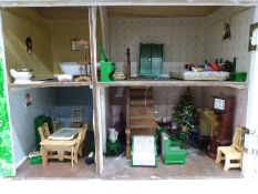 A painted doll's house containing a collection of doll's house furniture