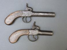 Two percussion hammer action pistols one with two inch screw off barrel, overall length 17cm,