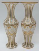 A pair of 19th century overlaid and cut glass vases,