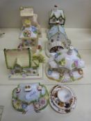A collection of Coalport Cottages including Parasol House and a Coalport miniature trio