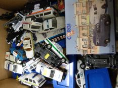 A collection of boxed and loose diecast toys, most police themed,