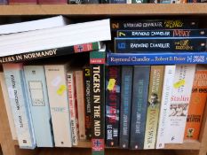 A collection of World War II related paperback books together with novels by John le Carre and