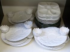A collection of oyster plates including faux majolica,