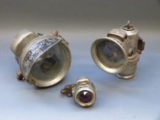 A Lucas Calica carbide lamp and Powell and Hamner motorcycle front and rear light