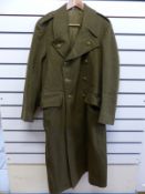 An army greatcoat marked size 8 and dated 1953 inside