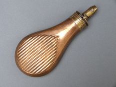 Sykes copper and brass powder flask with embossed reeded decoration, 19.5cm long.