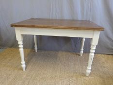 A pine kitchen table raised on turned legs (L114 x D76 x H75cm)