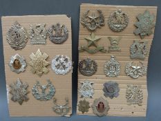 A collection of 25 Scottish regimental badges including Black Watch, Gordon Highlanders,