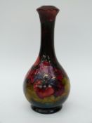 Moorcroft lamp in Hibiscus pattern by Walter Moorcroft with flambe glaze (22cm tall)
