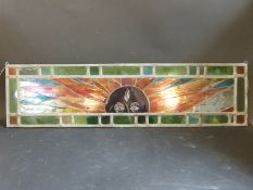 An Art Deco style stained glass window panel depicting a sunset,