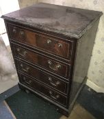 A reproduction mahogany cupboard in the form of a bachelor's chest of drawers.
