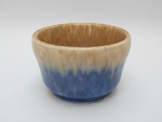 Ruskin studio pottery bowl on pedestal foot with brown top over blue base (11cm diameter)