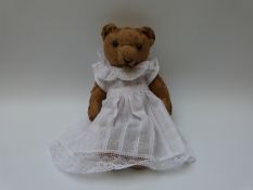 Blonde mohair teddy bear with hump back, central seam and jointed limbs, possibly Steiff,