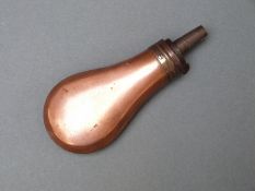 A copper and brass pistol powder flask with bevelled edge,
