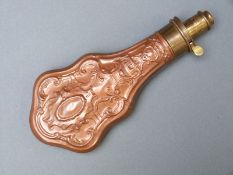 Sykes copper and brass powder flask with embossed decoration, 21cm long.