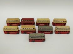 Nine Dinky Toys diecast model double decker buses, six in cream over red,