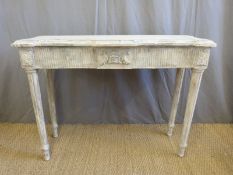 A shabby chic style console/side table raised on reeded legs