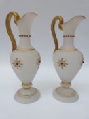 A pair of glass decorative ewers with jewelled decoration,