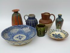 A collection of studio pottery including slip glaze examples and two stoneware jugs