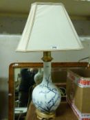 An enamelled ceramic lamp with prunus decoration and sqaure shade (H78cm)