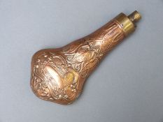Copper and brass powder flask of double gourd form with embossed decoration of vines and scrolls