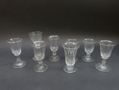 Eight 19thC wine glasses all with cut decoration and knopped stems, largest 12.
