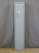 A metal four gun cabinet with spare keys