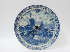 A blue and white Delft wall clock (diameter 33cm)