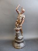 A cast metal figure of a blacksmith,
