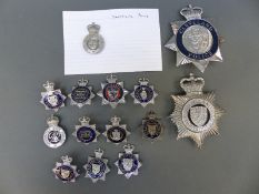 A collection of various police badges including Cleveland, City of Sheffield, Dewsbury,